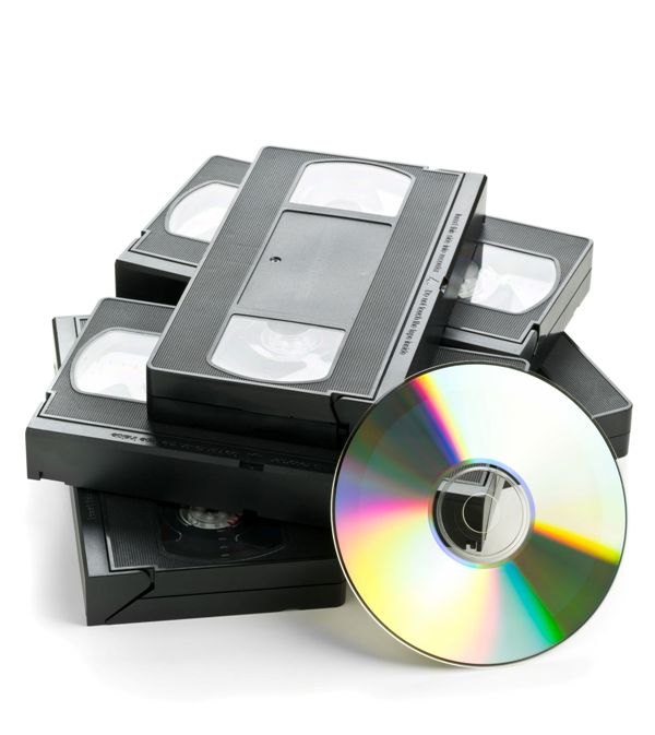 Heap of analog video cassettes with DVD disc